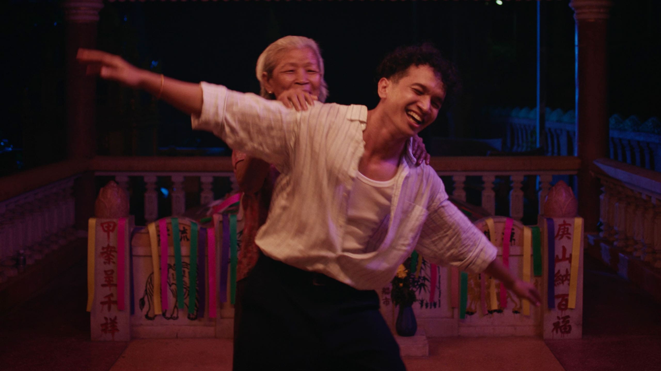 Grandma Nai and her grandson laughing and dancing together